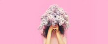 Portrait Of Woman Covering Her Head With Bouquet Of Fresh Lilac Flowers On Pink Background