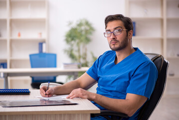 Young male doctor working in the clinic