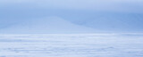 Winter arctic landscape. View of the snow-covered tundra and mountains. Panorama of the snowy arctic desert. Cold weather. The harsh climate of the polar region. Northern nature. Natural background.