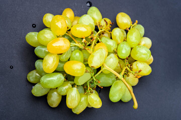 Wall Mural - White or green grapes isolated on black background