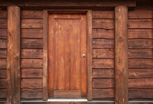 Wooden Front Door In To Rustic Cabin. Wooden Wall With Old Door. Rustic Log Cabin With Front Door In The Forest BC.