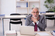 © Elnur - Old male employee working in the office