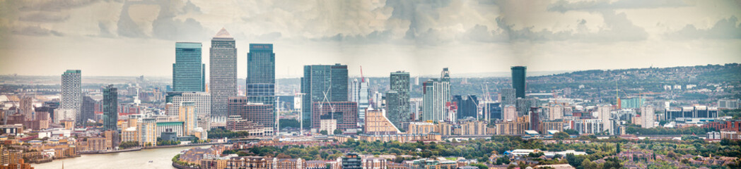 Poster - London - UK. Aerial panoramic view of Canary Wharf modern buildings on a cloudy day