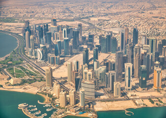 Canvas Print - Aerial view of Doha skyline from airplane. Corniche and modern buildings, Qatar