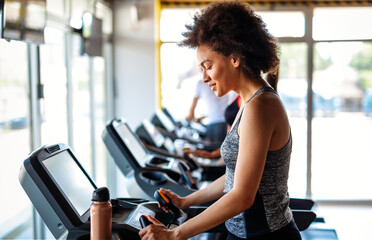 Group of happy fit people at the gym exercising, running. Stay healthy concept.