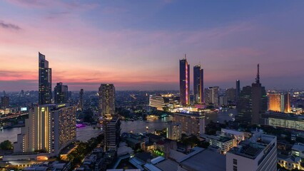 Wall Mural - Sunset over illuminated landmark building in downtown and cruise ship on Chao Phraya riverside in Bangkok