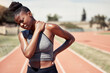 © L Ismail/peopleimages.com - Fitness, burnout or black woman runner with neck pain from sport training, running workout or exercise at race stadium. Tired, sports first aid or muscle injury girl for health, back pain or wellness