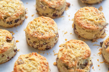 A Tray Of Baked Savory Bacon Scones With A Sprinkles Of Cheddar And Parmesan Cheese On Top 