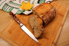 Bread On A Cutting Board With A Knife