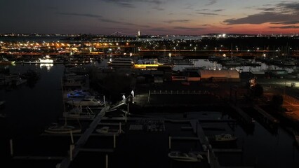 Wall Mural - Aerial video of night new york city with with port and road lit by lanterns