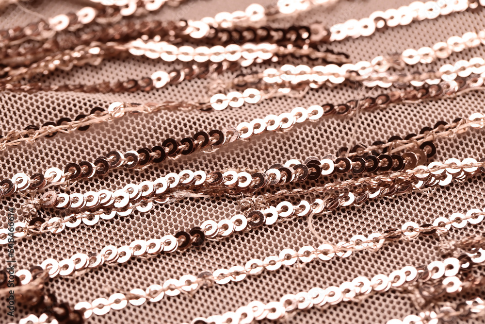 Closeup view of cloth with golden sequins as background