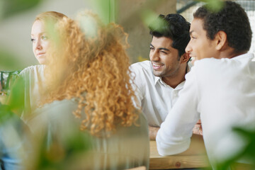 Canvas Print - Business team, meeting and planning in a restaurant with a man and woman employee group working in collaboration. Teamwork, strategy and training with male and female colleagues at work in a cafe