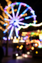 Beautiful Blurred And Defocused Colorful Lights Of A Garland On A Carousel. Christmas Fair.