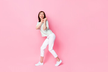 Poster - Photo of pretty cute lady person dressed trendy striped clothes arms pull hold carry empty space isolated on pink color background