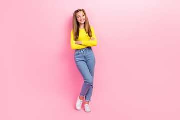 Poster - Full length photo of dreamy sweet schoolgirl wear yellow crop top looking empty space arms folded isolated pink color background