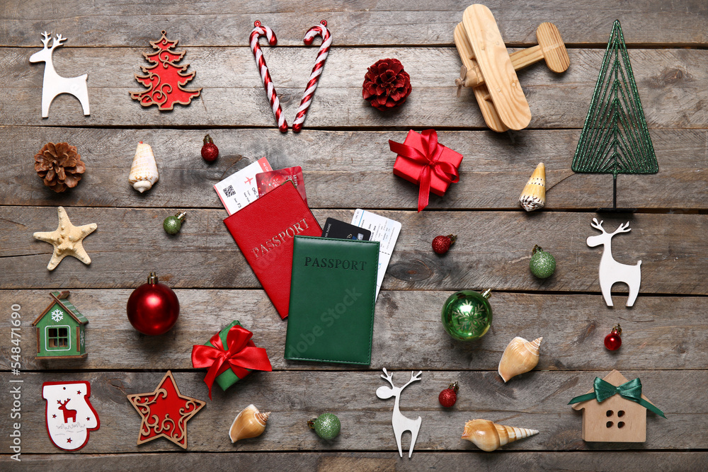 Passports with Christmas decor and seashells on dark wooden background