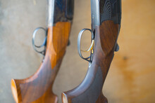 Two Double-barreled Shotguns Stand On A Stand. Weapon Close-up, Rifle For Hunting.