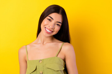 Wall Mural - Photo of charming shiny young girl dressed clothes smiling empty space isolated yellow color background