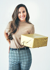 Wall Mural - Christmas, birthday or holiday with woman giving gift or present to celebrate and surprise on a studio background. Portrait of a female with a smile, happiness and kindness holding a mockup gift box