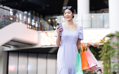 Wall Mural - happy Asian woman shopping at mall