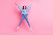 Full size portrait of satisfied cheerful girl jumping make star figure isolated on pink color background