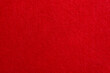 Red texture velour or felt cloth close-up. Natural or artificial sewing material. Fabric as background for design.
