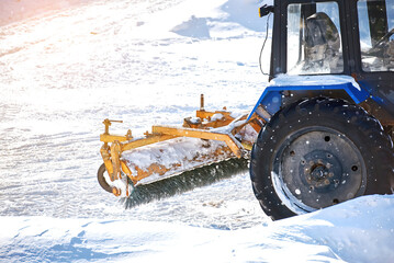 Wall Mural - Tractor mounted snow sweeper brush, tractor broom for sweep snow. Winter machinery cleaning equipment.