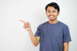 © DMH - Smiling or happy handsome young Asian man with his finger pointing isolated on white background with copy space
