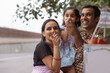 © IndiaPix - Portrait of happy family standing near street shop