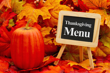 Wall Mural - Thanksgiving menu on a chalkboard with fall leaves
