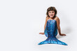 © ADDICTIVE STOCK - Charming girl sitting in studio in mermaid costume