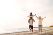 © Kiattisak - Happy asian family enjoy the sea beach at consisting father, mother and daughter having fun playing beach in summer vacation on the ocean beach. Happy family with vacations time lifestyle concept.