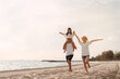 © Kiattisak - Happy asian family enjoy the sea beach at consisting father, mother and daughter having fun playing beach in summer vacation on the ocean beach. Happy family with vacations time lifestyle concept.