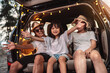 © Kiattisak - Happy Family with car travel and camping road trip. summer vacation in car in the sunset, Dad, mom and daughter happy traveling enjoy together driving in holidays, people lifestyle ride by automobile.