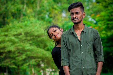 Two indian college best friends posing together.