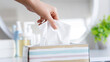 women hand picking napkin tissue paper from the tissue box