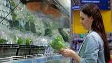 Close-up Portrait, Beautiful, Pretty Young Woman, Chooses Green Leafy Vegetables In A Grocery Store