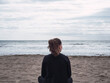 © Dani - Young lonely pensive woman on the beach looking at the sea