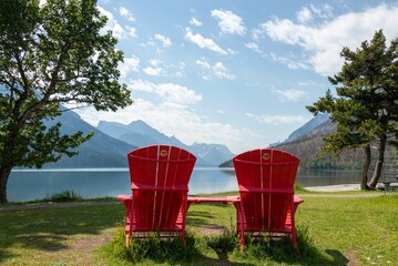 Sticker - Adirondack red chairs on the beach along the shore of Waterton Lake National Park Canada