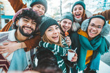 Multicultural friends wearing winter clothes enjoying winter vacation together - Happy young people celebrating new year eve - Friendship and winter holidays concept