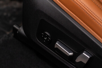 Electric car seat adjustment control panel close up view. Adjustable car seat position. Car interior.