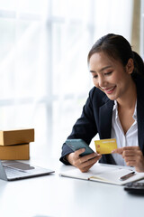 Asian businesswoman hands holding smartphone shopping online with a credit card. Online Payment. Online shopping