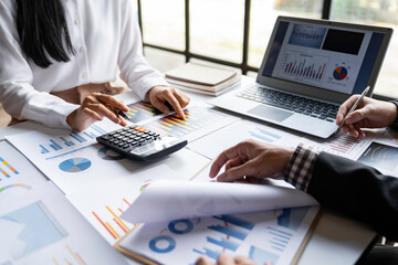 The business team that operates on the table checking data, Concept financial transactions online of a businessman, Financier being checked about financial transactions past computer with teamwork.