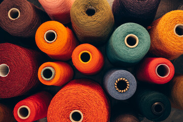 Composition of colorful vibrant wool threads from above.