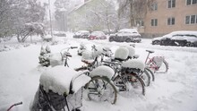 Cars And Bikes Covered In Snow During Heavy Snowfall