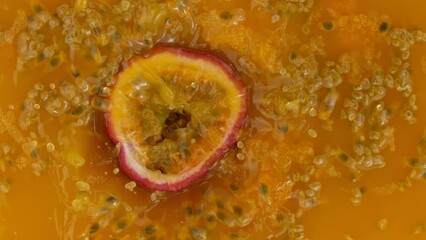 Poster - Fresh sliced passion fruit falling into juice, super slow motion filmed on high speed cinematic camera at 1000 fps.
