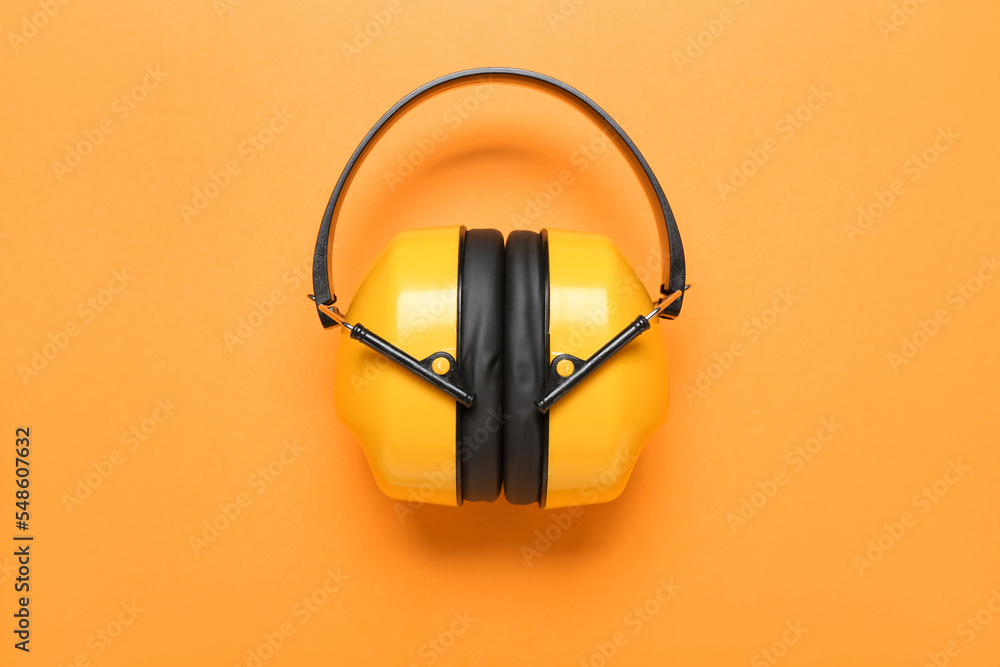 Hearing protectors on color background