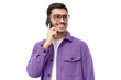 Portrait of handsome young man in purple shirt and glasses, answering phone call, looking aside with smile
