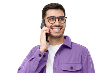 Wall Mural - Cheerful young man in purple shirt and glasses, talking on the phone and laughing to joke