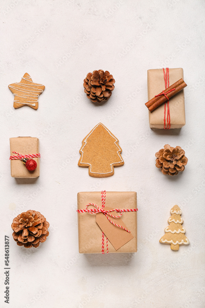 Composition with Christmas gifts, cookies and cones on light background